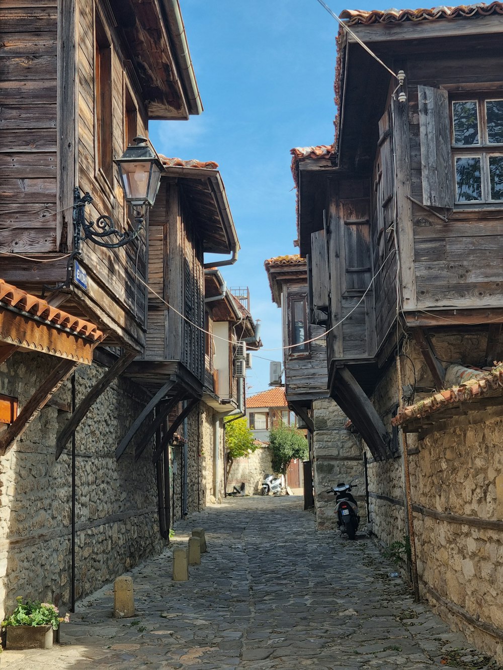 a cobblestone street with wooden buildings on both sides