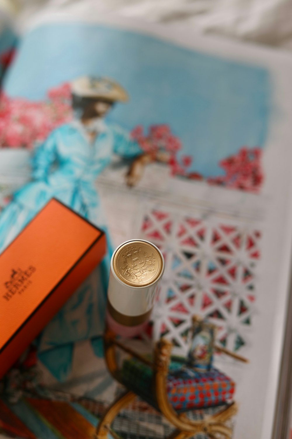 a small bottle of perfume sitting on top of a book