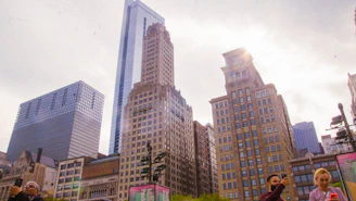 Colorful cityscape from a vibrant mobile game showing lively streets and growing skyscrapers.