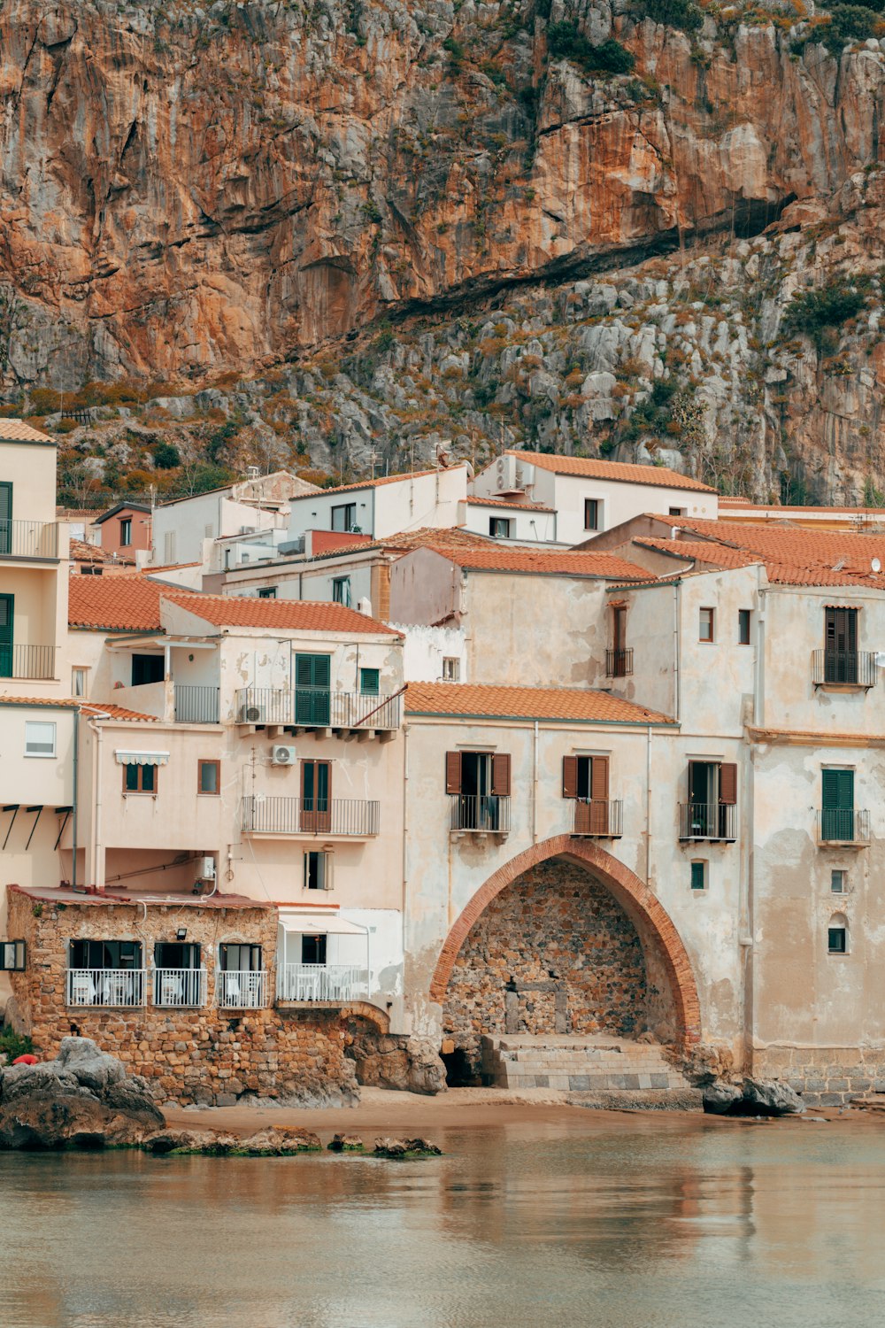 a group of buildings sitting on the side of a river