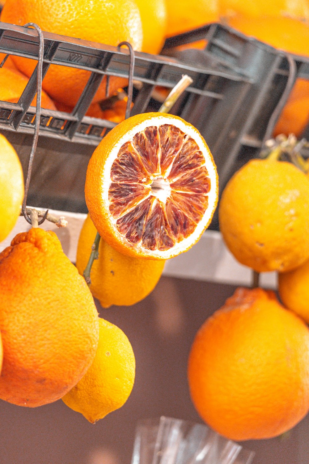 a bunch of oranges that are on a rack