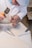 An artisan working on a marble inlay project, showcasing detailed craftsmanship and tools.