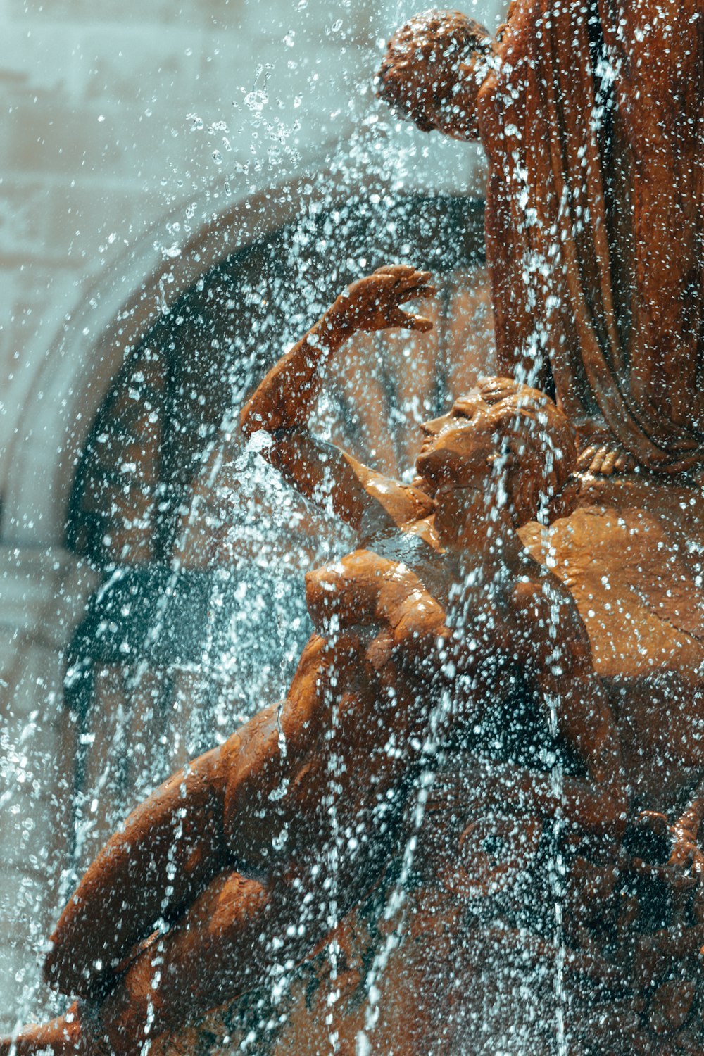 a statue of a woman holding a child in the water