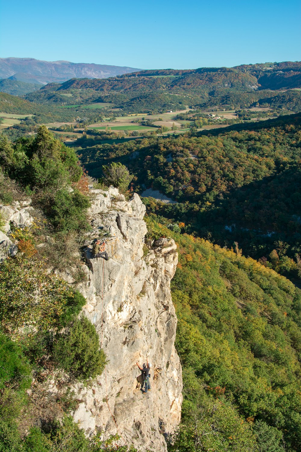 a man climbing up the side of a mountain