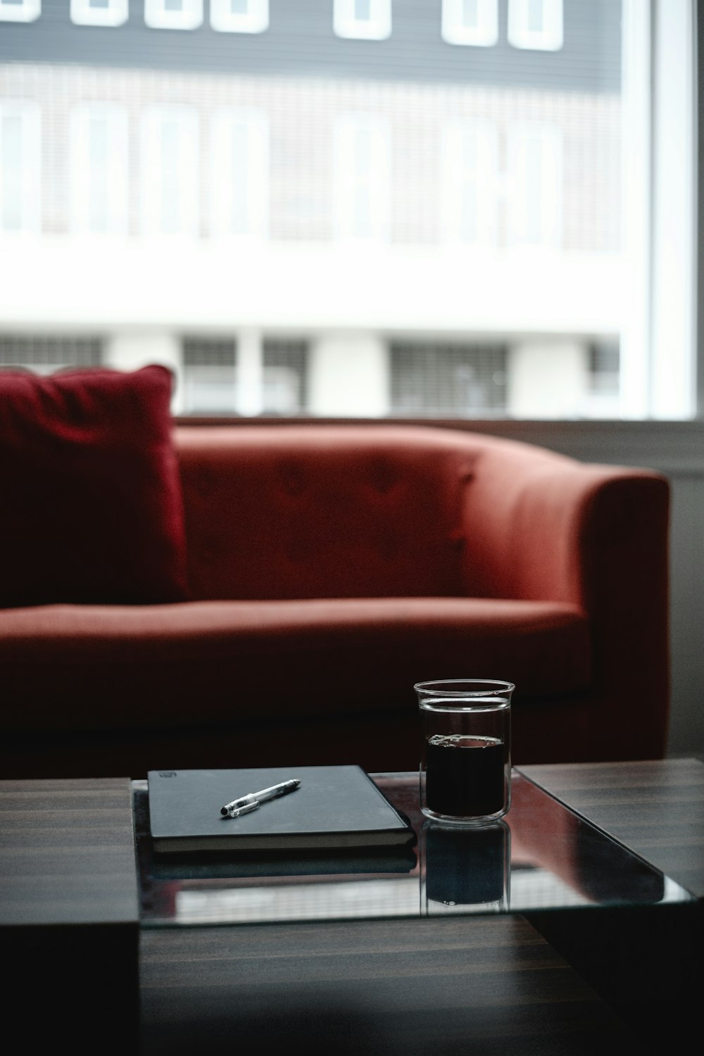 a glass of water sitting on a table in front of a couch