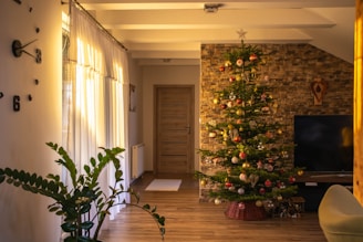 A warmly lit living room adorned with Christmas wreaths, twinkling lights, and a decorated tree.