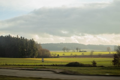 A peaceful stretch of rural land with open fields and a clear blue sky.