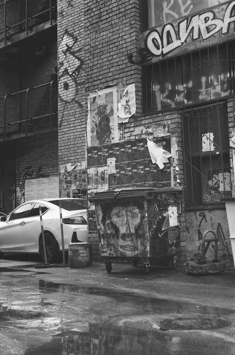 a car parked in front of a building with graffiti on it