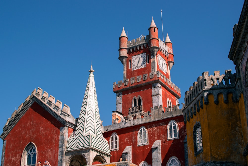 a large red building with a clock tower