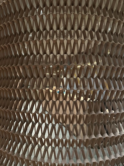Close-up of honeycomb-structured recycled paper wrap protecting a delicate ceramic vase.