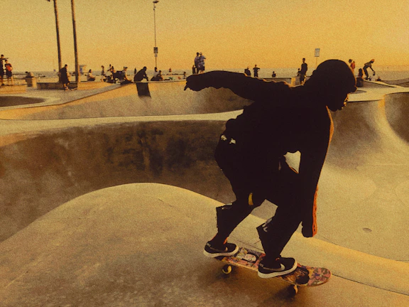 Action shot of a skater wearing Sentra Skate apparel grinding on a rail at dusk.
