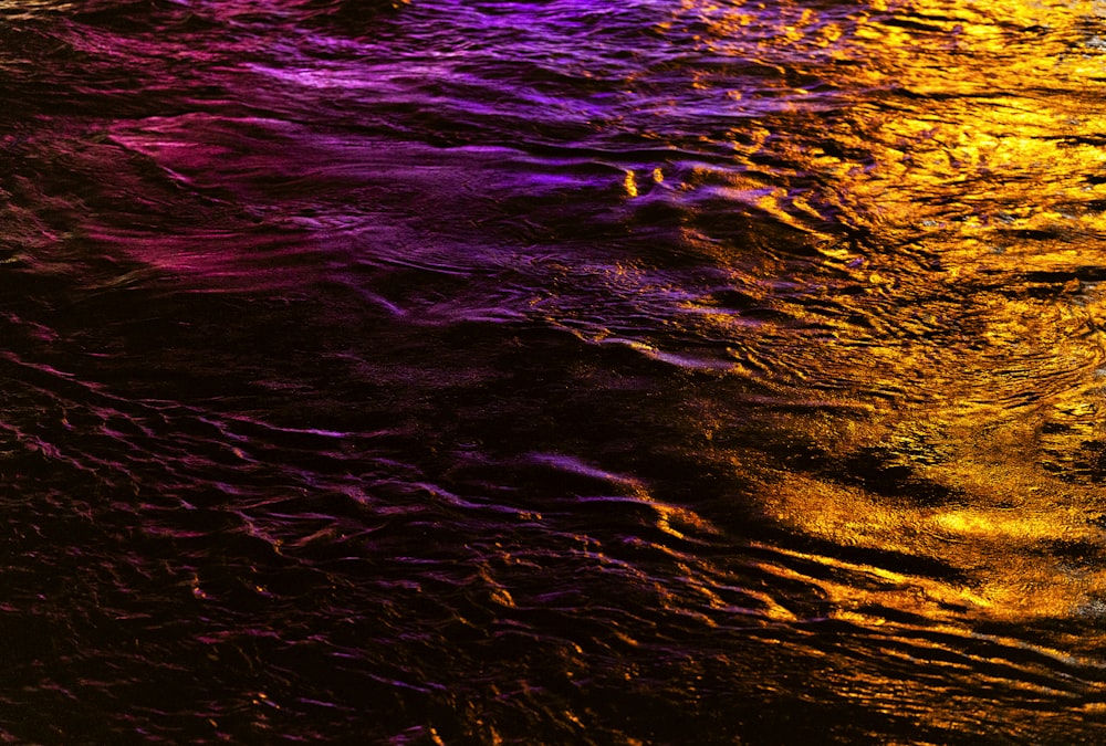 a close up of a water surface at night
