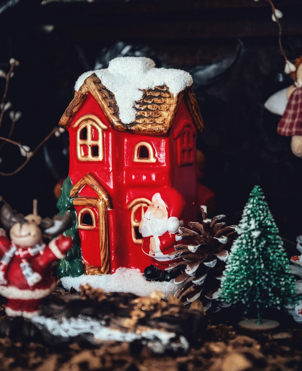 a christmas scene with a red house and santa clause decorations