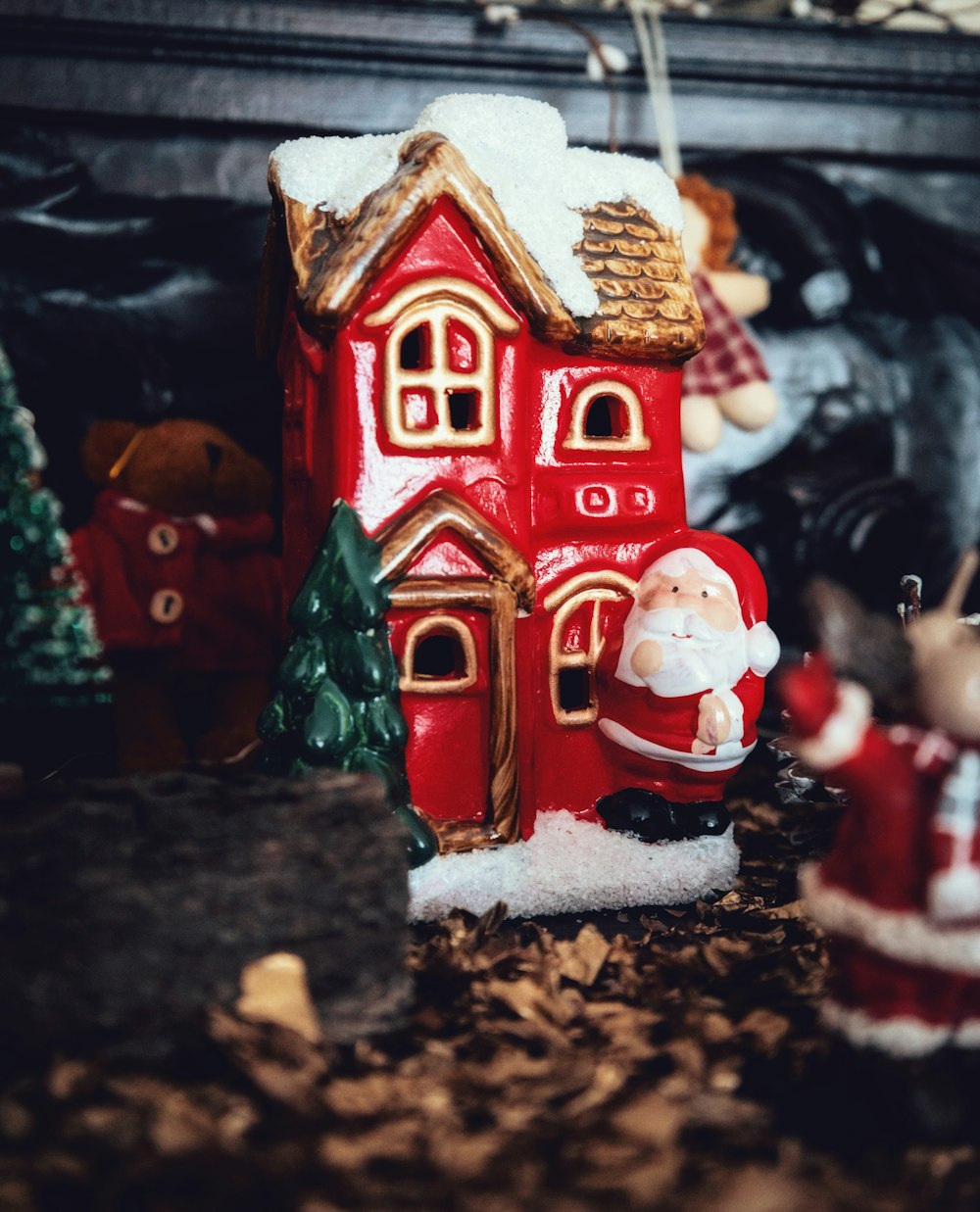 a red house with a santa clause figure next to it