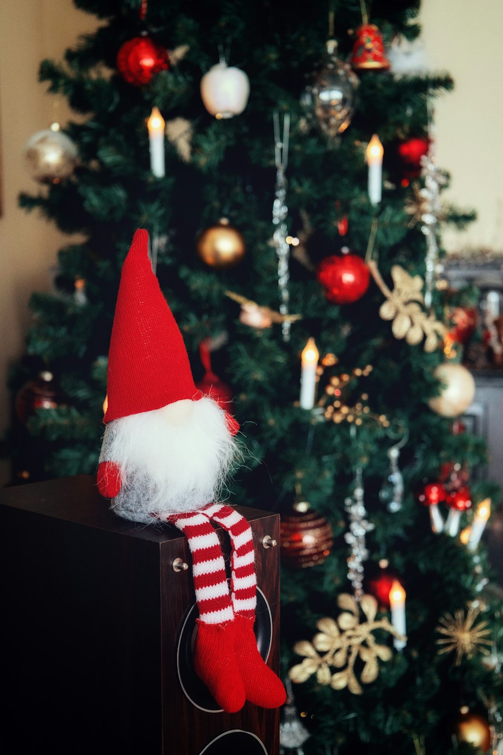 a red and white santa hat sitting on top of a wooden box