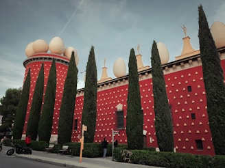 a red building with a lot of trees in front of it