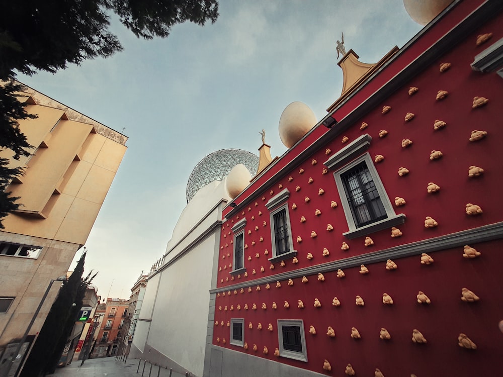 a red building with a white dome on top of it