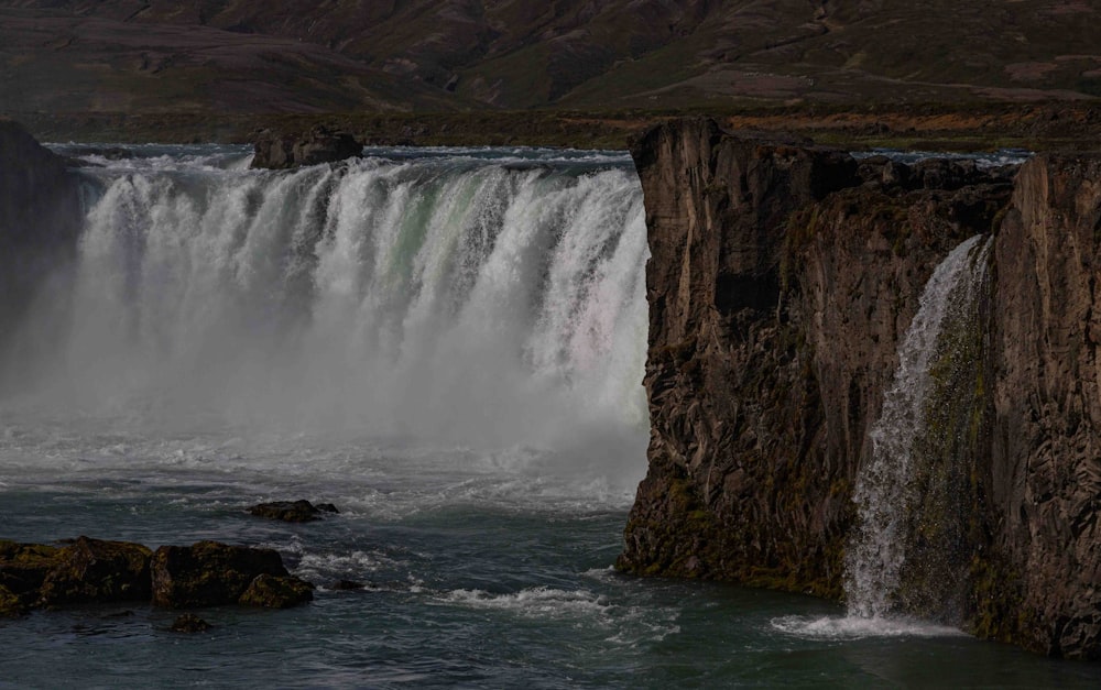 a large waterfall with water coming out of it