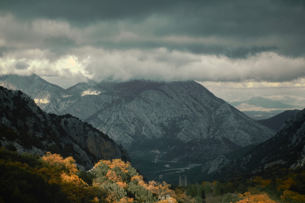 a view of a mountain range with clouds in the sky