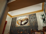 An intricate painting displayed in a hotel suite.