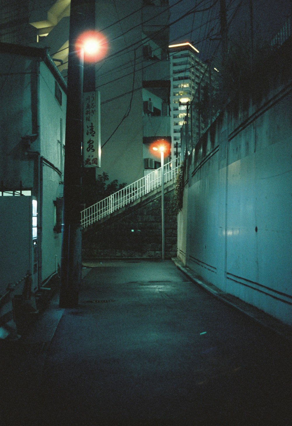a dark alley at night with street lights
