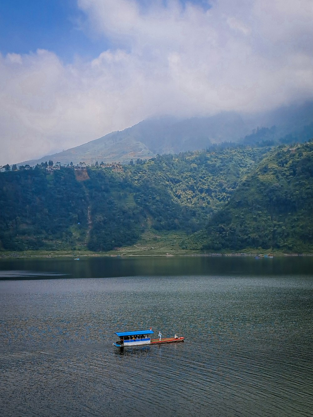 a small boat floating on top of a lake