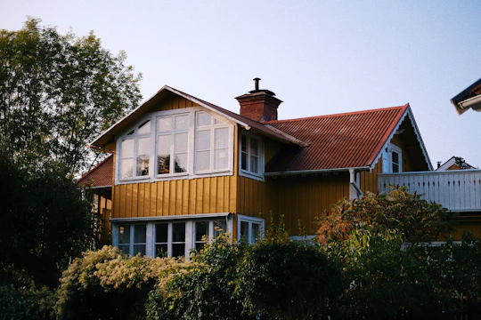 A charming Chilean house with a warm wooden facade and a small garden.
