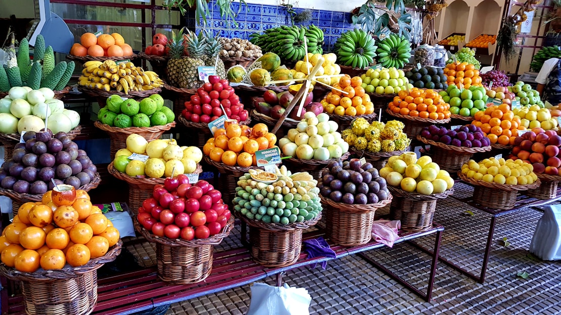 A vibrant display of fresh tropical fruits from Alanya alongside handcrafted silk cocoon bridal flowers made by local women.