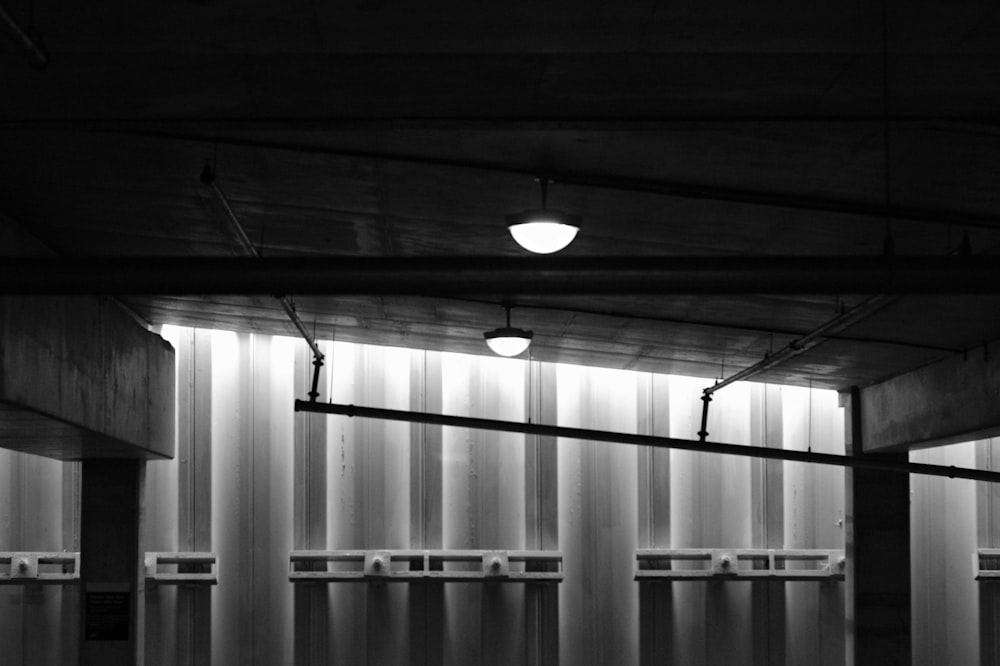 a black and white photo of a row of urinals