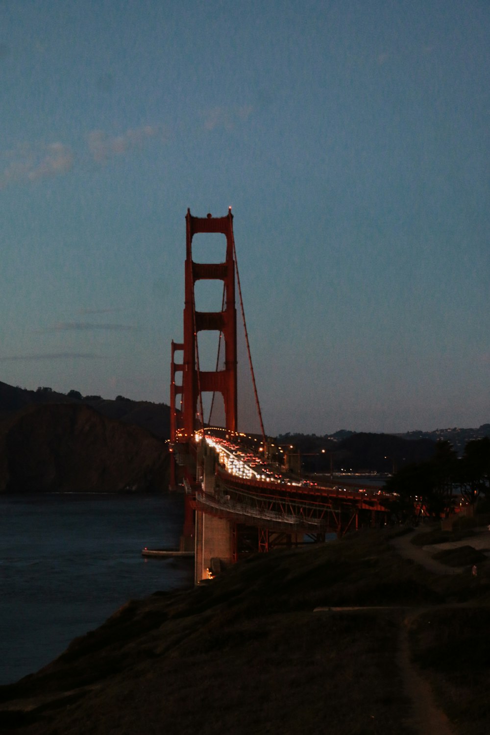 the golden gate bridge is lit up at night