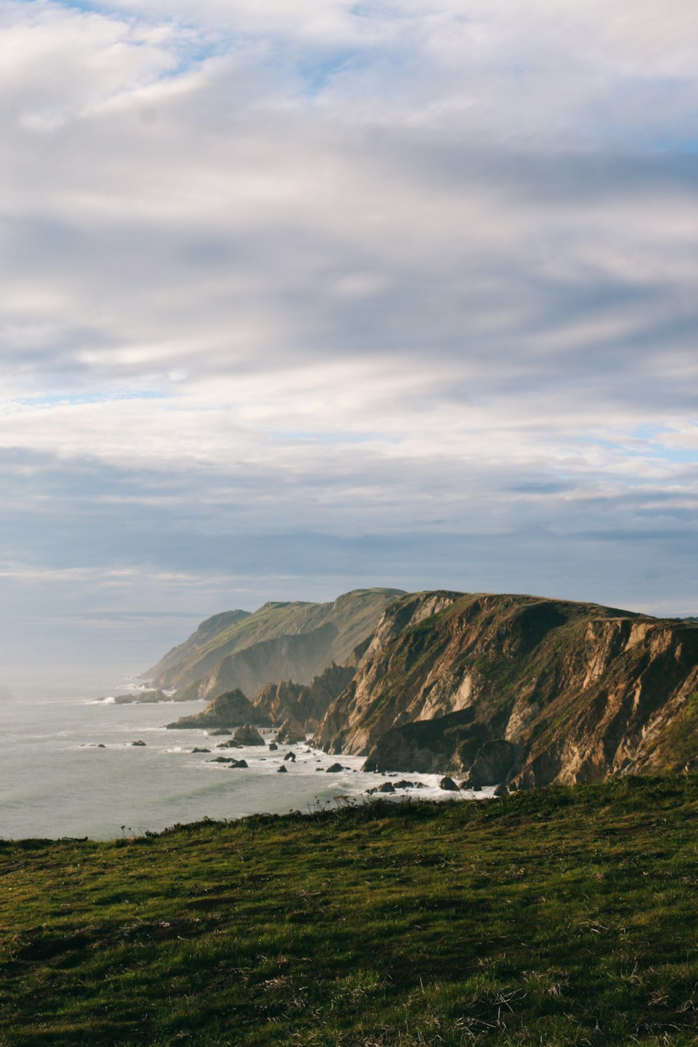 a view of the ocean from the top of a hill