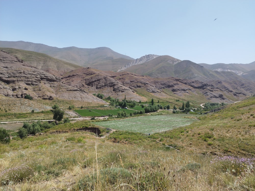 a view of a valley with mountains in the background