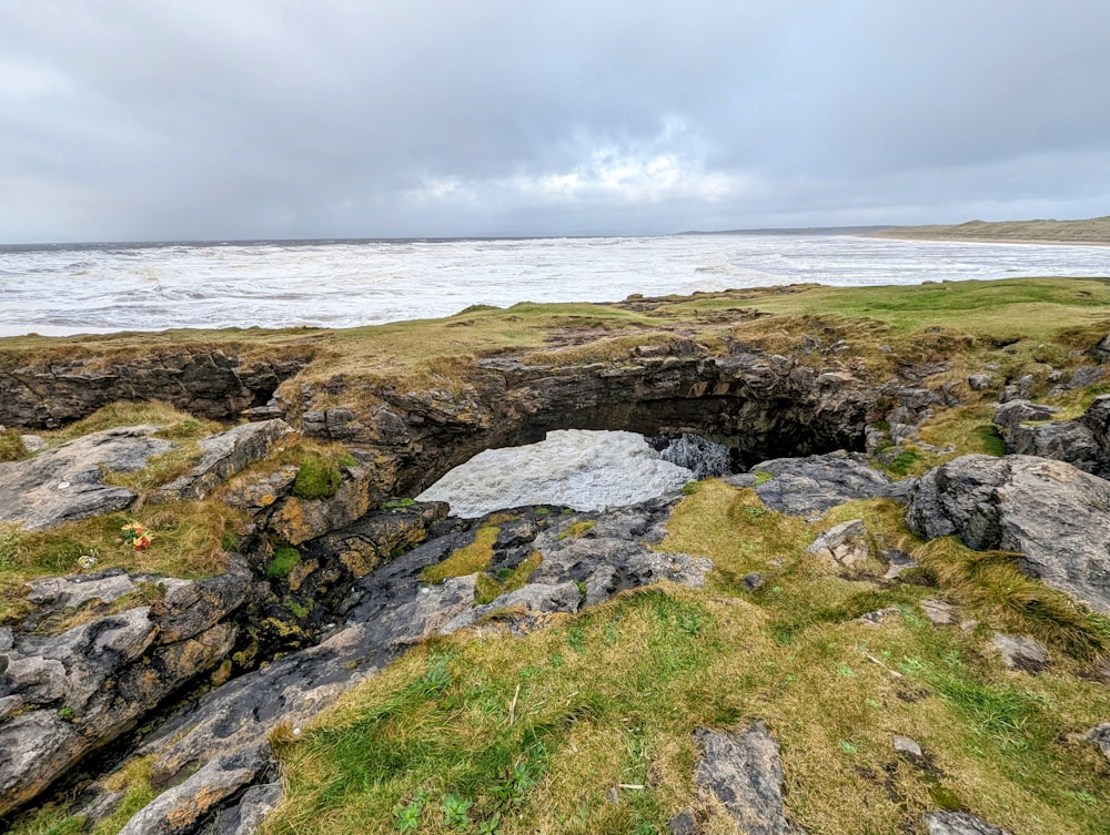 a rocky area with a hole in the middle of it