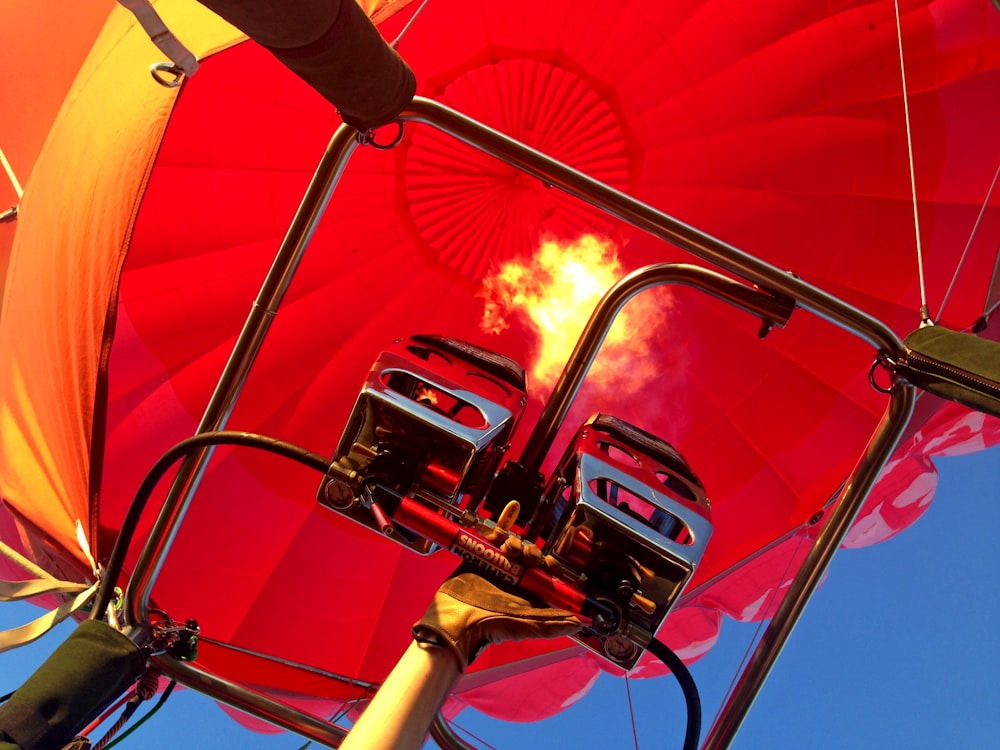 a red and yellow umbrella with a blue sky in the background