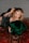 A woman with styled blonde hair is lying on a richly patterned Persian carpet. She is wearing a black, mesh-like dress embellished with sequins and holding a luxurious green fur or fabric. Her makeup is elegantly done with red lipstick and eyeliner.