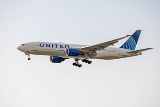 a large jetliner flying through a cloudy sky