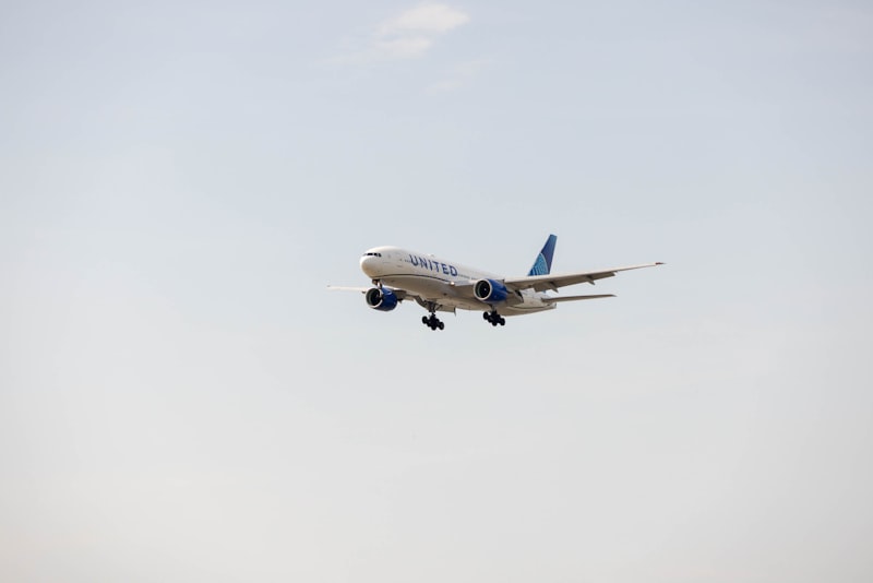 A large commercial jetliner flying through a blue sky