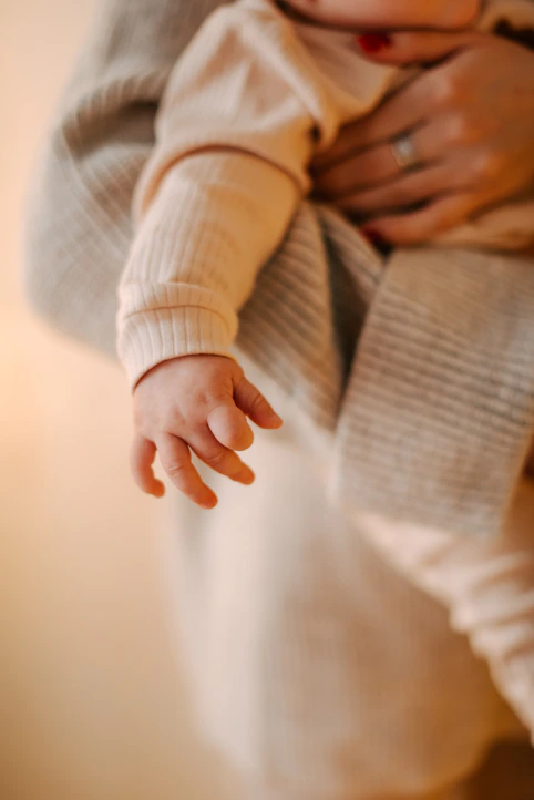 a close up of a person holding a baby