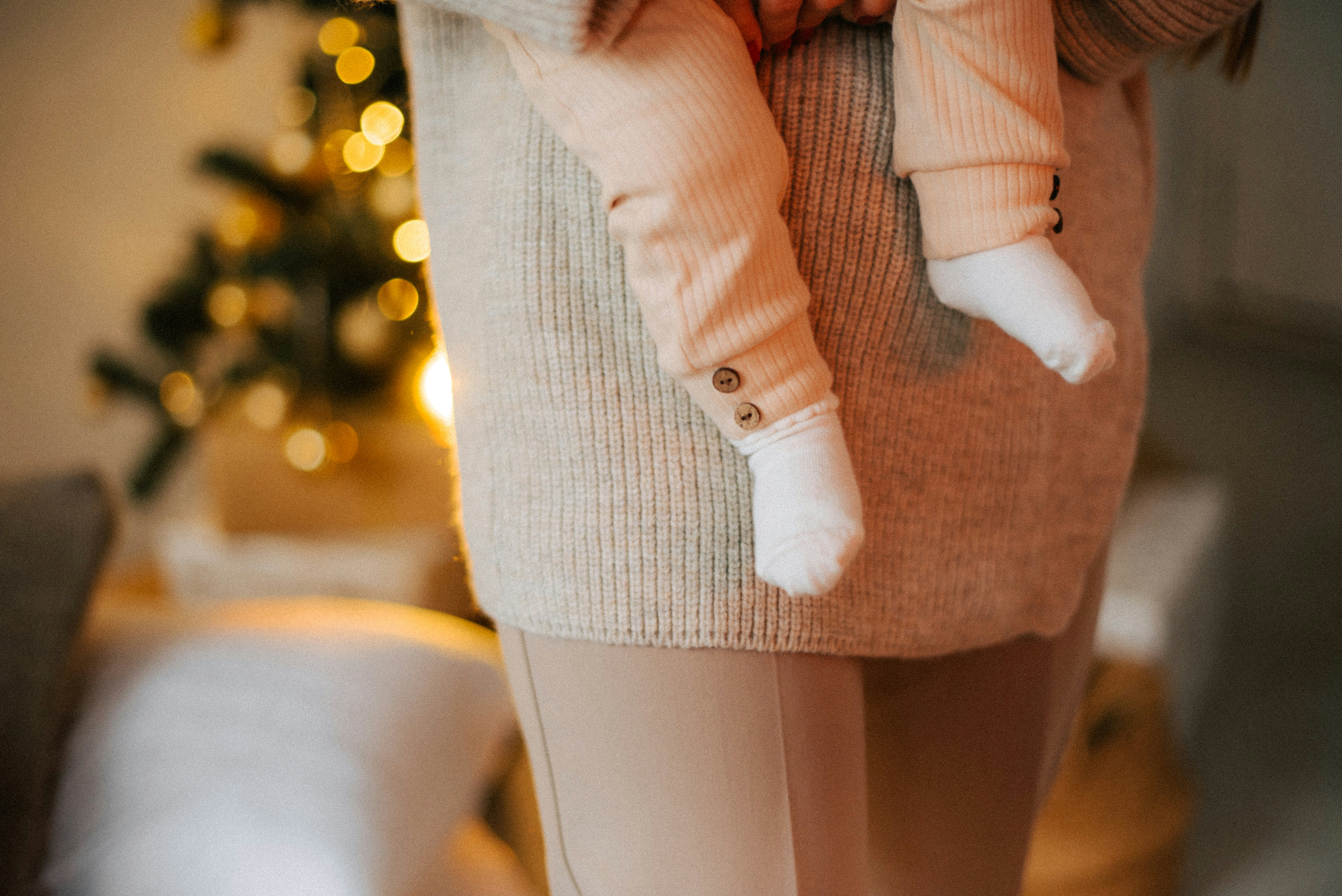 a woman holding a baby in her arms