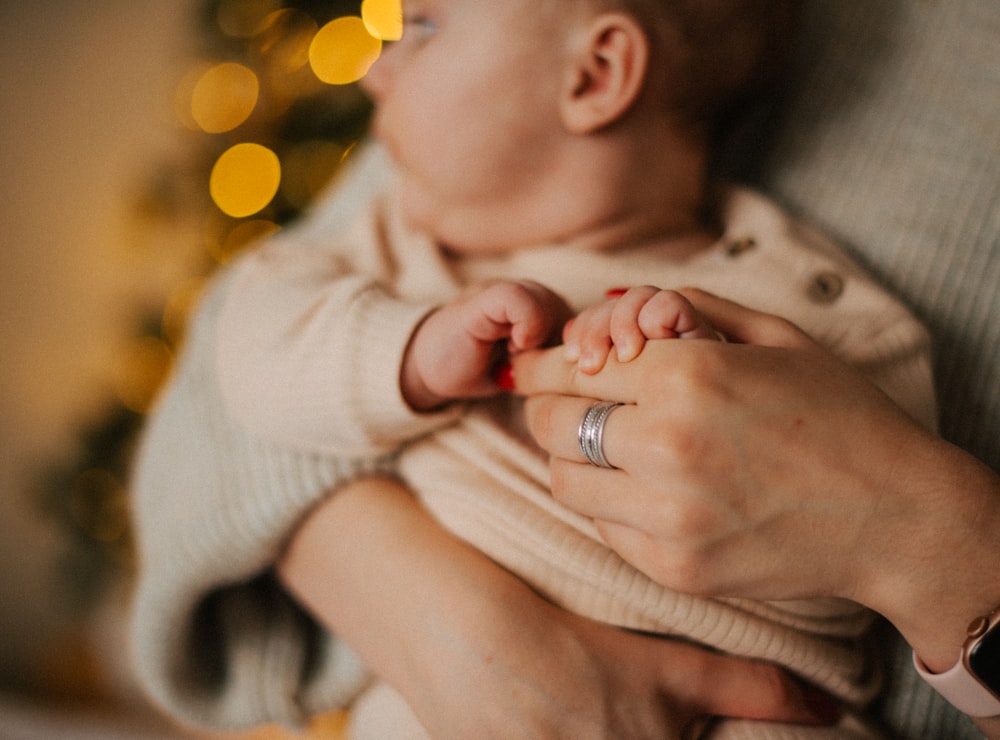 a woman holding a baby in her arms