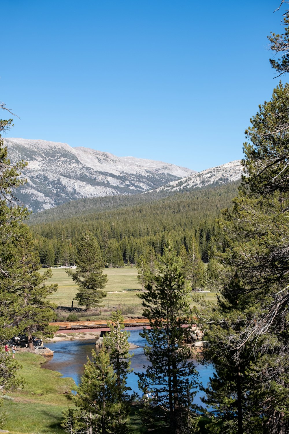 a scenic view of a mountain range with a lake in the foreground