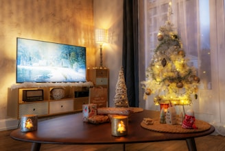 A cozy living room beautifully decorated with a minimalist Christmas tree, glowing string lights, and whimsical snowflake ornaments.