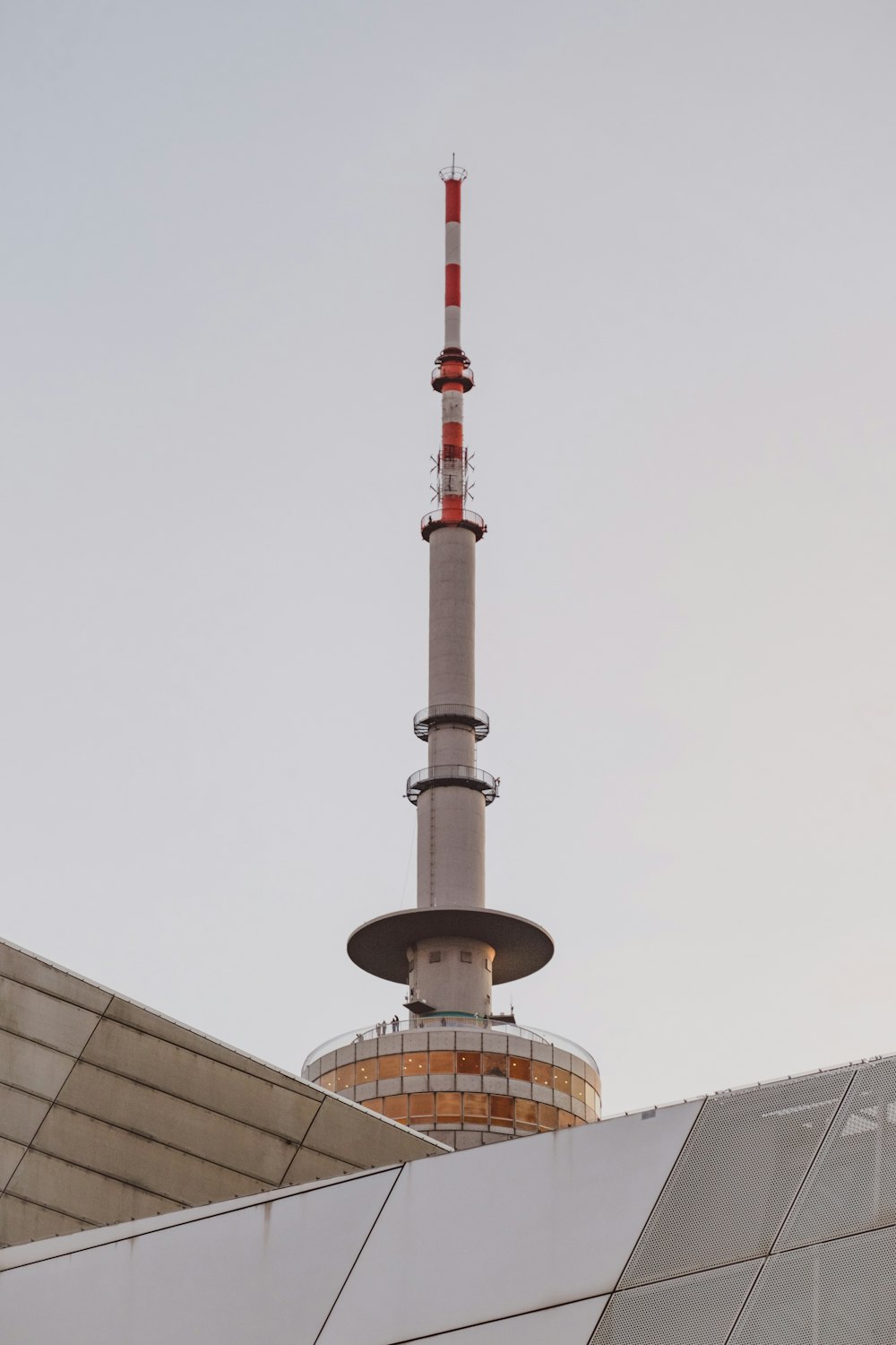 un'alta torre con una bandiera bianca e rossa in cima