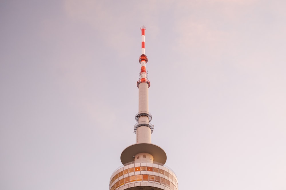 a tall tower with a red and white top