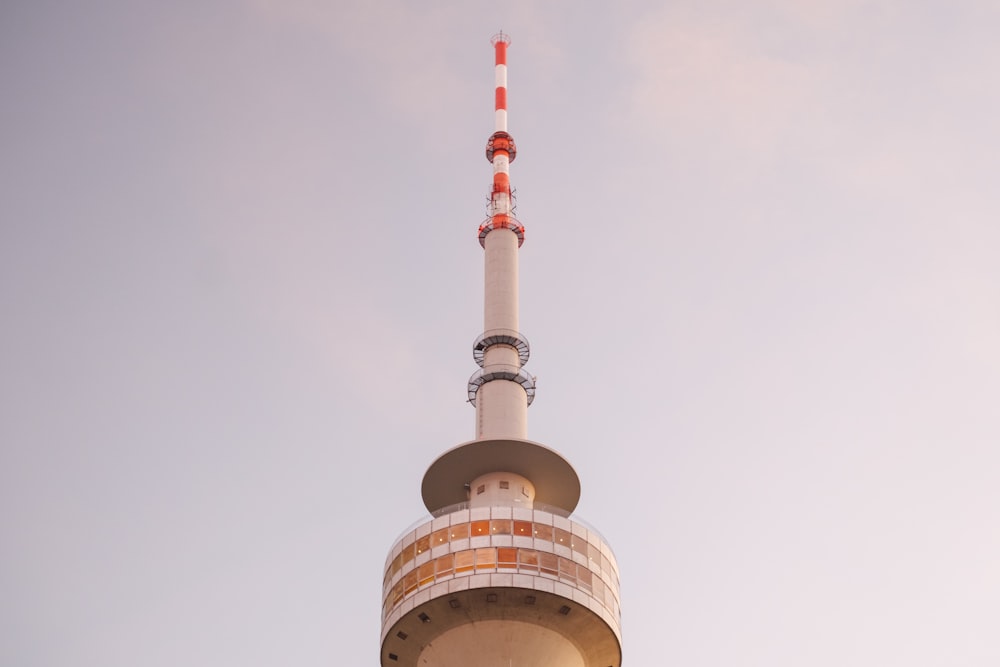 a tall tower with a red and white top