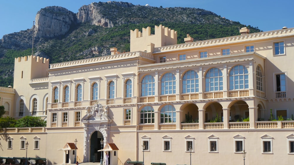 a large building with a mountain in the background