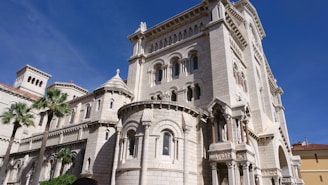 a large white building with a clock on the front of it