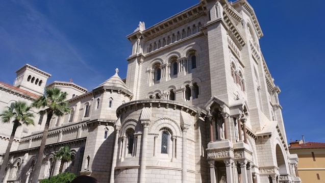 a large white building with a clock on the front of it