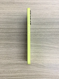 A sleek smartphone displaying the Yeşilfikir app interface with vibrant green buttons on a dark grey background.
