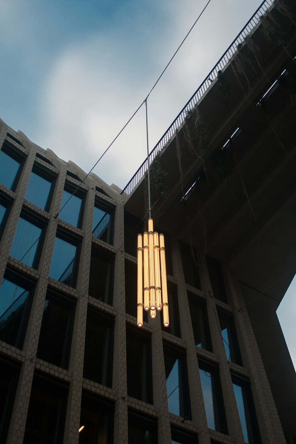 a tall building with a light hanging from it's side